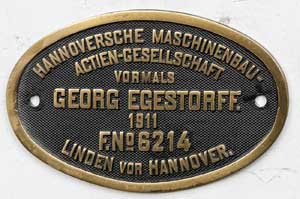 Fabrikschild Georg Egestorff. Fabriknummer: 6214, Baujahr: 1911. Messingguss oval, Riffelgrund mit Rand. B x H =&nbsp;214 x 133 mm. Das Schild ist von der DRG 98 125.