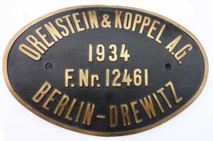 Fabrikschild Orenstein & Koppel A.G., Berlin-Drewitz. Fabriknummer: 12461, Baujahr: 1934, Messingguss, oval, Riffelgrund mit Rand, Zylinderschild. Das Schild ist von der DRG 64 330.