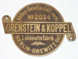Fabrikschild Orenstein & Koppel, Lokomotivfabrik Berlin-Drewitz. Fabriknummer: 2034, Baujahr: -, Messingguss, rund, Riffelgrund mit Rand. Das Schild ist von der ?