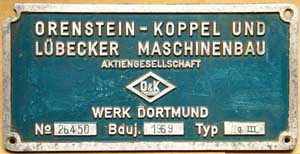 Fabrikschild O&K, Fabriknummer: 26450, Baujahr: 1969, Aluminiumguss rechteckig, Riffelgrund mit Rand (GAlmR). Das Schild ist von einer Kf LG III.