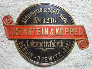 Fabrikschild Orenstein & Koppel, Lokomotivfabrik Berlin-Drewitz. Fabriknummer: 3216, Baujahr: -, Messingguss, rund, Riffelgrund mit Rand. Das Schild ist von der ?