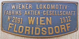 Fabrikschild Wiener Lokomotiv- Fabriks-Aktien-Gesellschaft Wien-Floridsdorf. Fabriknummer: 2091, Baujahr: 1912, Messingguss, rechteckig, Riffelgrund mit Rand, Domschild. Das Schild ist von der BBÖ 197.302.
